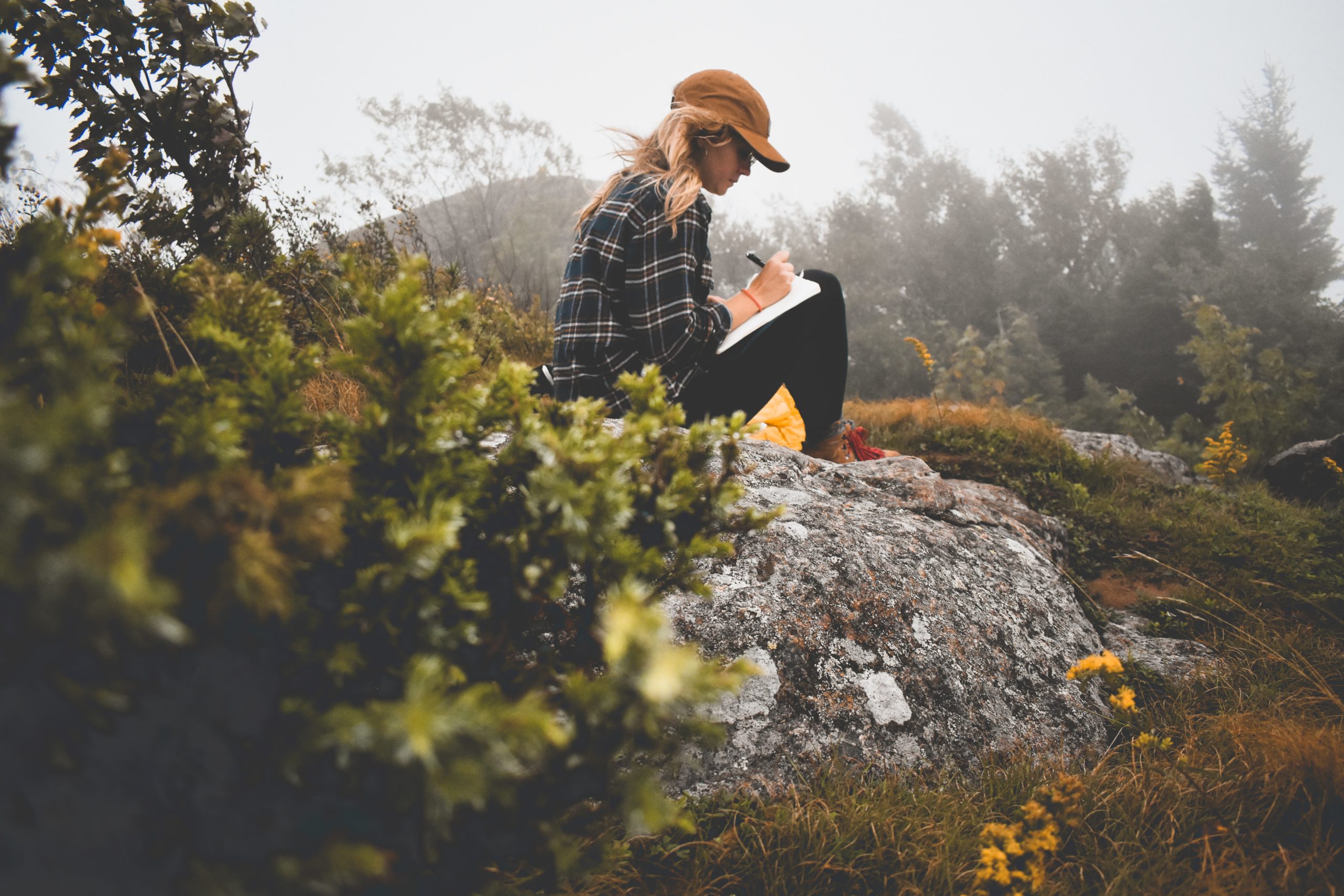 a woman journaling on a hike